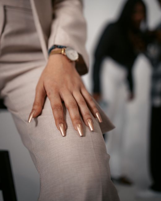 Close-up of a stylish hand pose showcasing fashion and elegance in a studio setting.